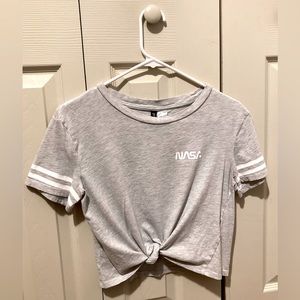 The shirt is a crop top. It’s easy to style. You simply tie the two strings.